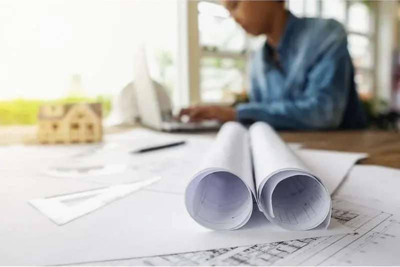Engineer reviewing building inspection blueprints and documentation