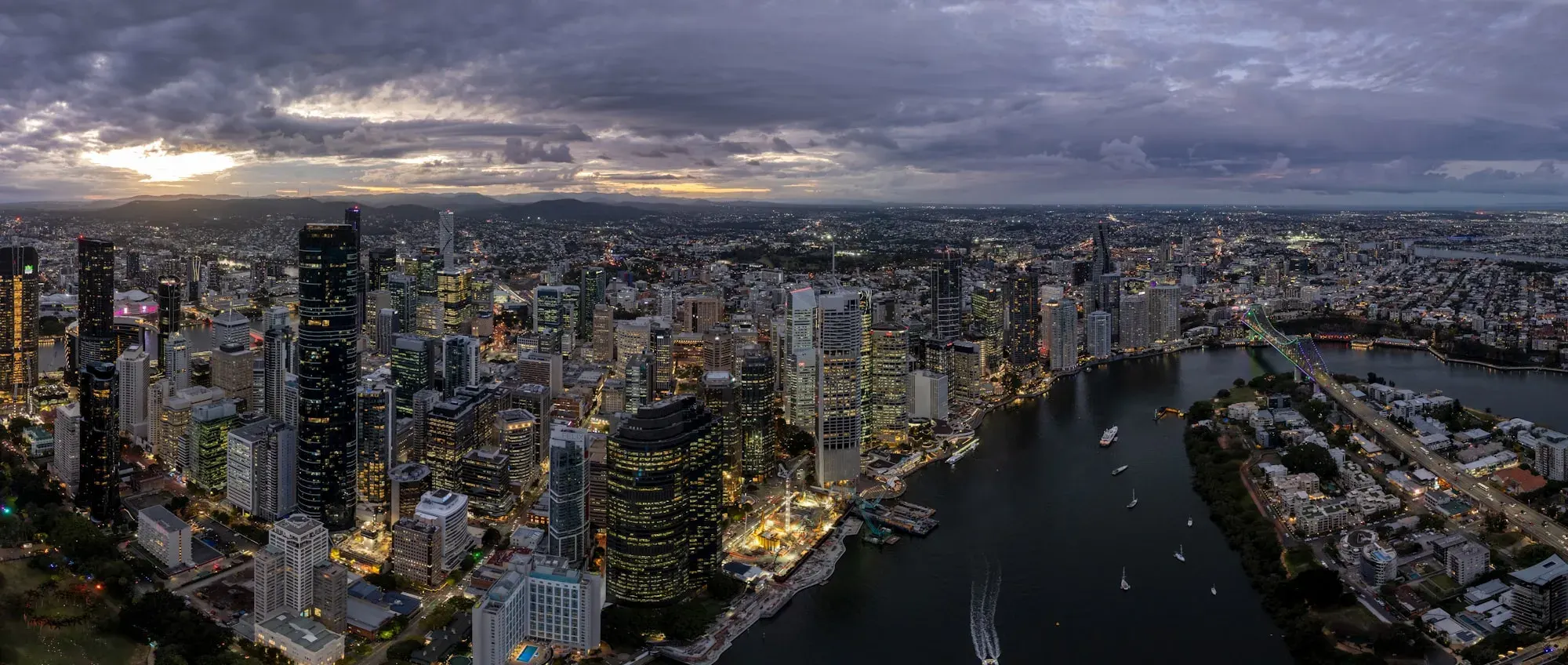 Brisbane CBD aerial view at dusk with Brisbane River - building inspections across Queensland