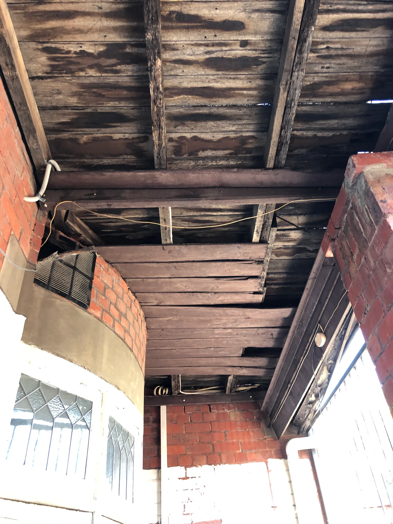 Long term water staining and timber deterioration across ceiling joists in an accessible verandah