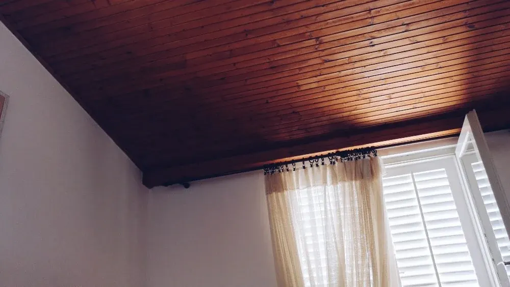 Various ceiling materials including drywall, plaster, and wood in home interior