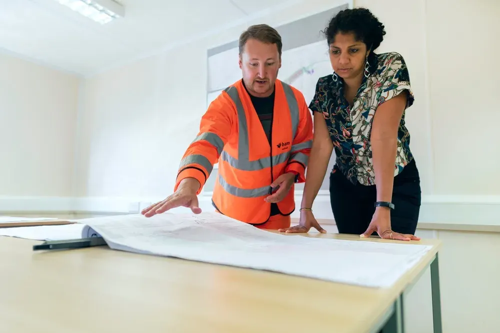 Building inspector and homeowner reviewing a pre-handover inspection at a new construction home