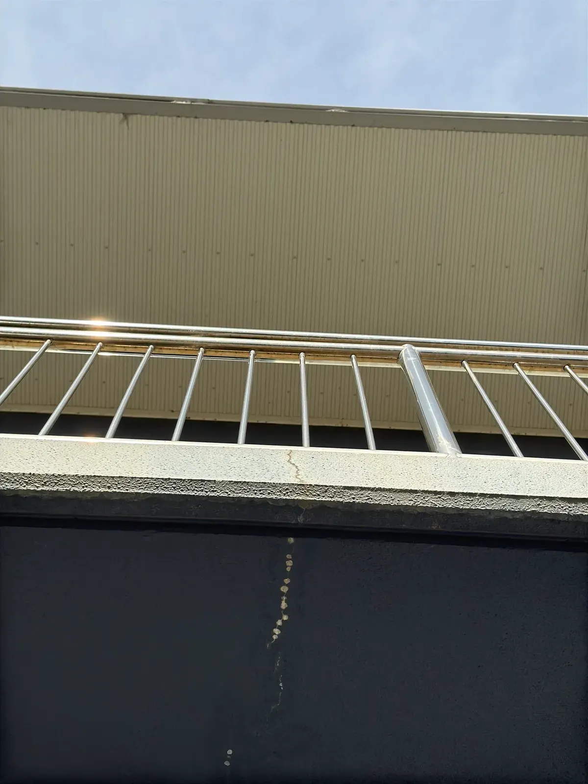 Crack with moisture staining below an upper balcony landing, recorded during a property inspection in Penrith NSW