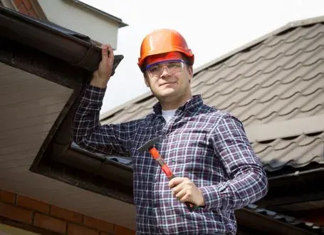Licensed inspector examining roof tiles on an Australian home during a roof inspection