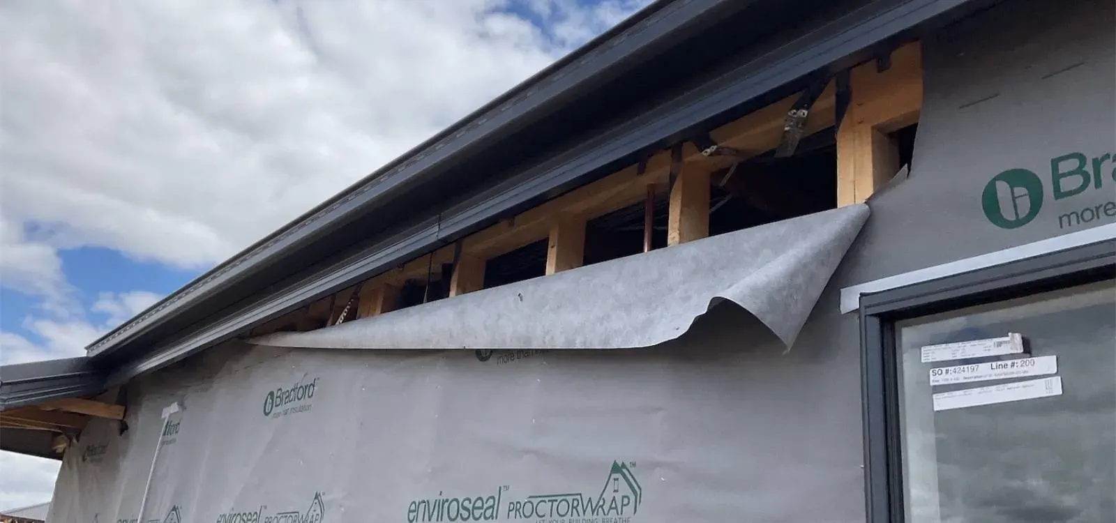 Building inspector checking insulation and weatherproofing during a lock-up stage inspection