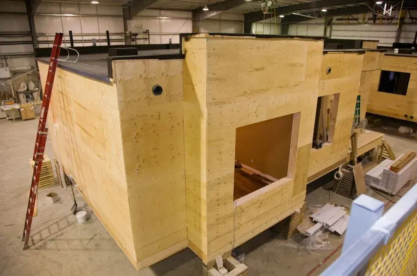 Modern prefabricated home module being craned into position on an Australian building site