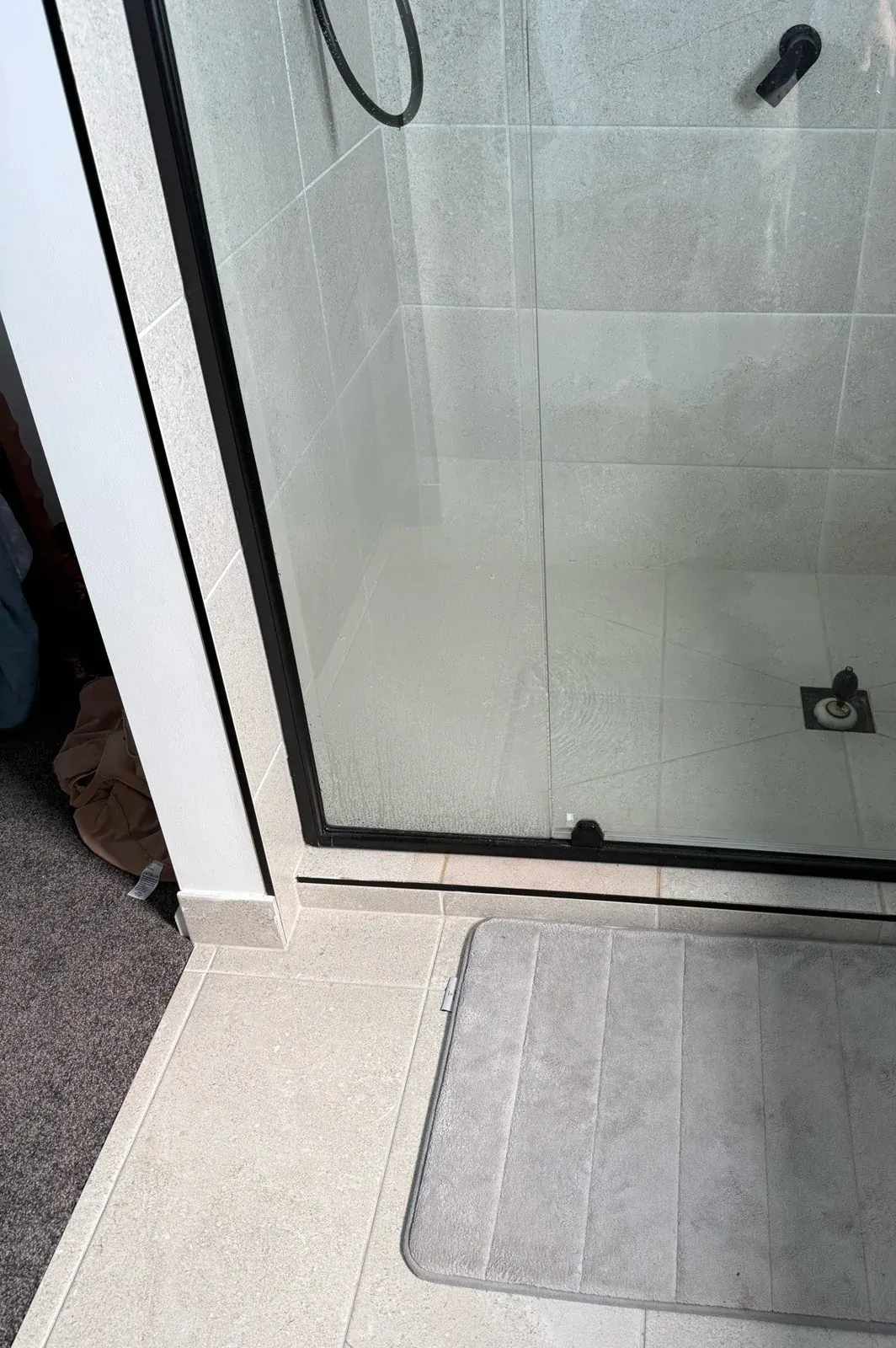 Shower in a rental bathroom tested for hot water and shower head rating