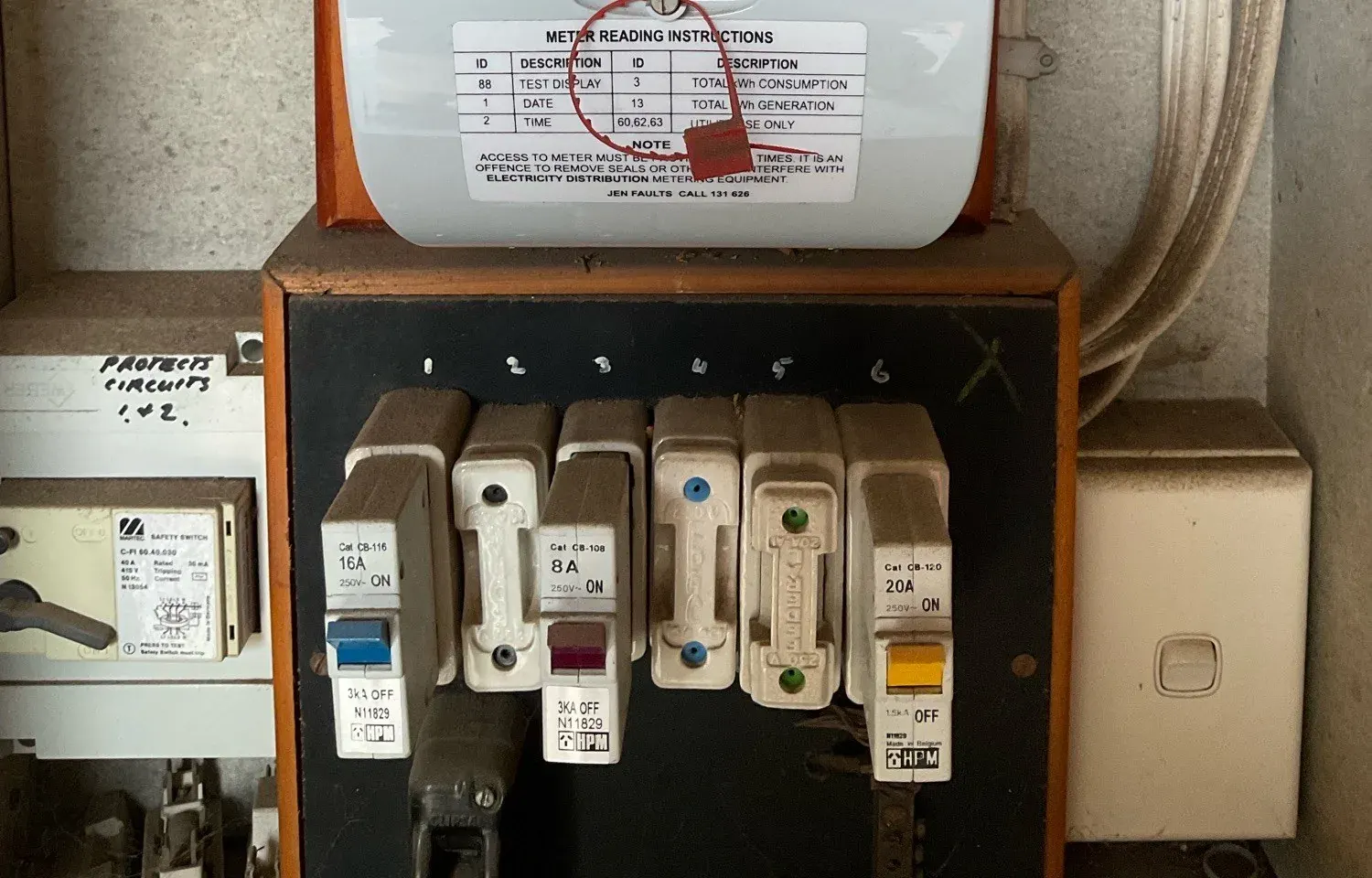 Old fuse switchboard in a rental that needs a licensed electrician to upgrade
