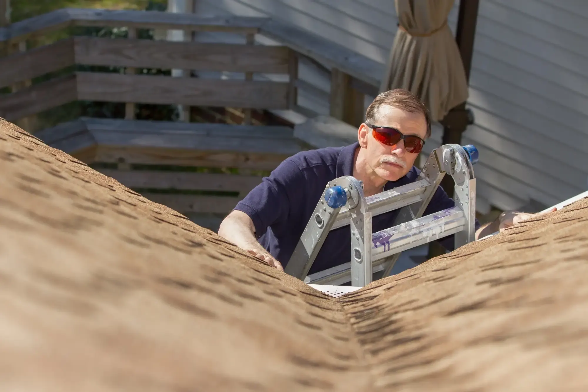 Licensed building inspector examining roof tiles and flashing during a defect inspection on an Australian home
