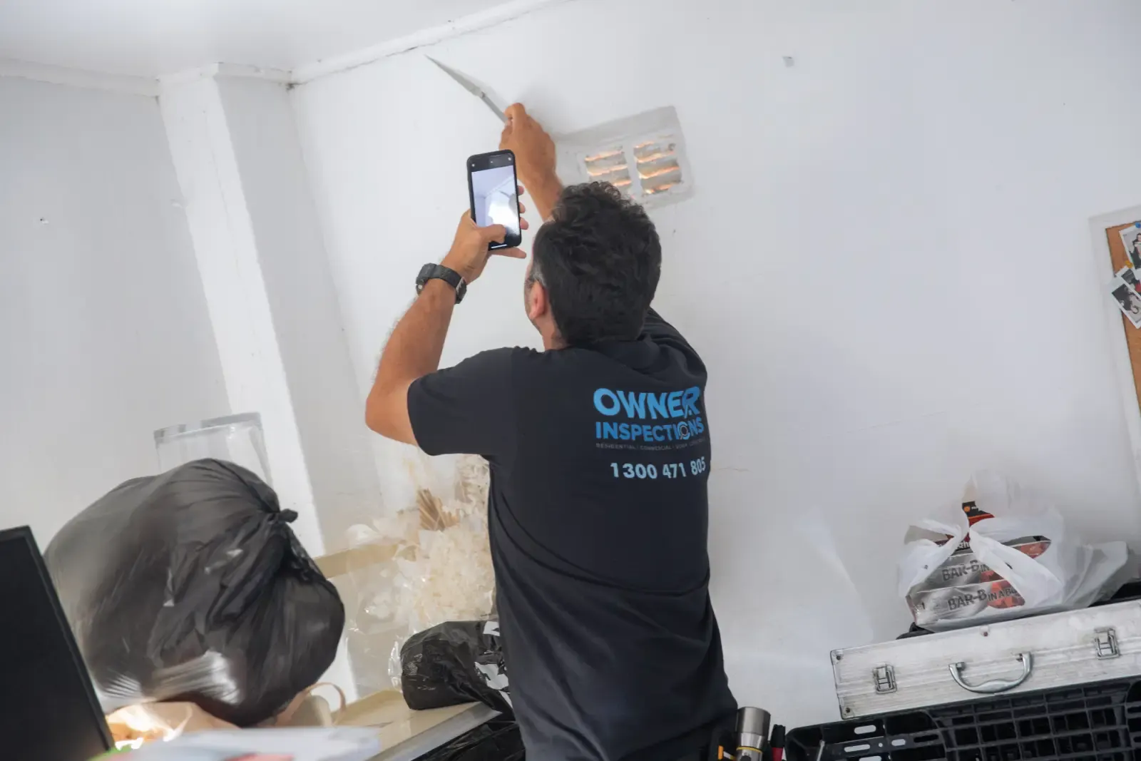 Building inspector conducting a maintenance inspection on an Australian residential property