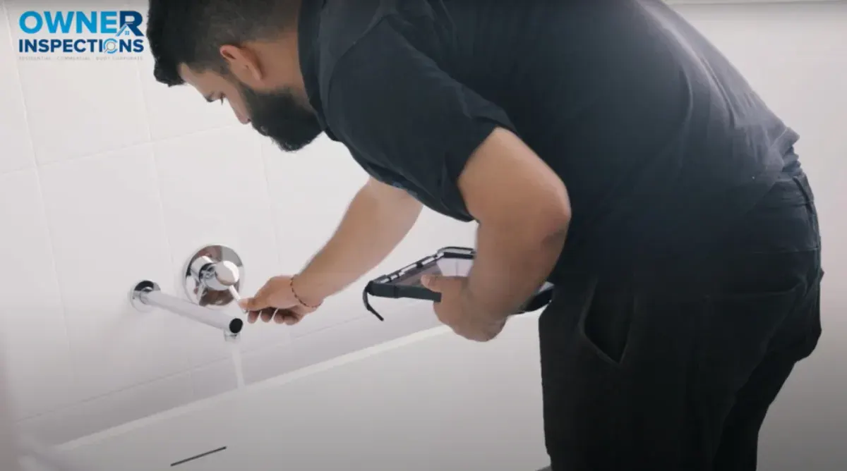 Building inspector checking plumbing during a property inspection in Victoria