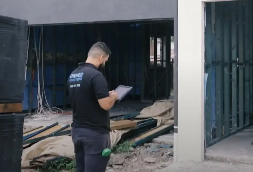 Qualified building inspector preparing a dilapidation report for a Brisbane property