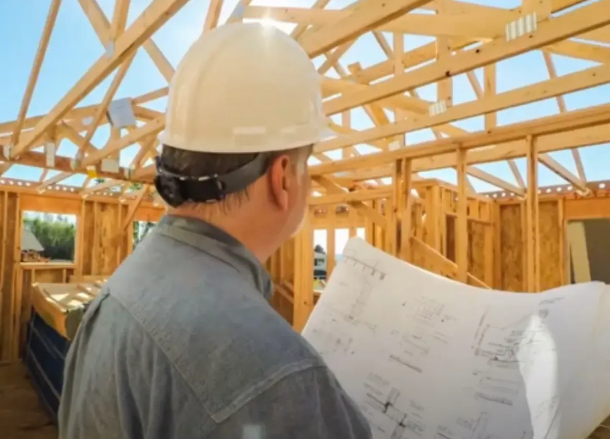 Private building inspector reviewing construction plans during a frame inspection in Melbourne
