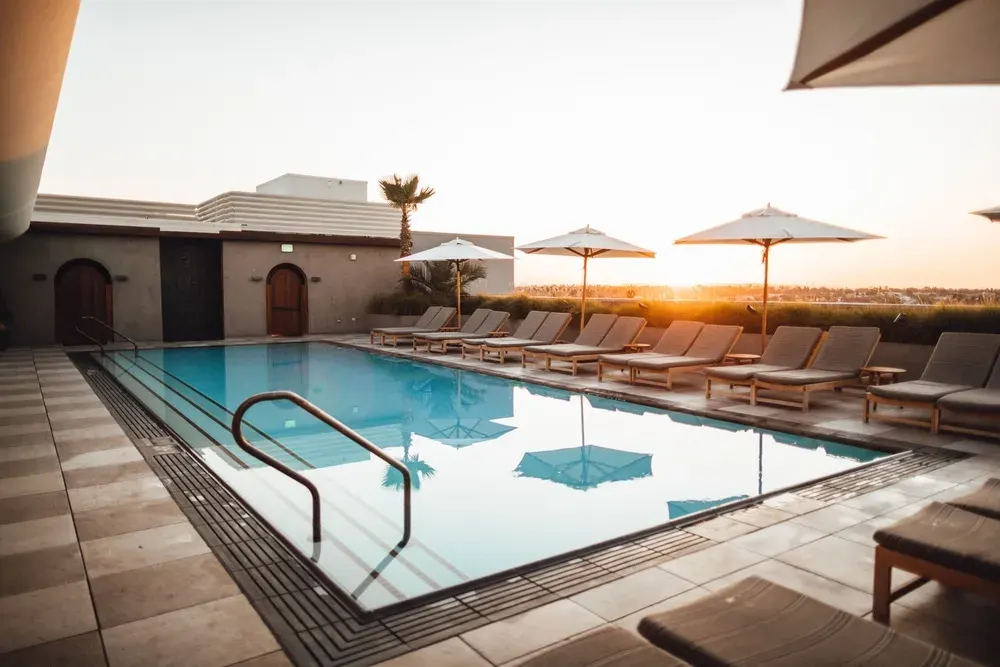 Australian homeowner maintaining a clean backyard swimming pool