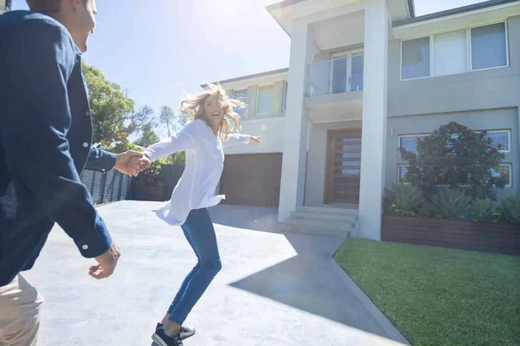 two happy couples going inside their new house
